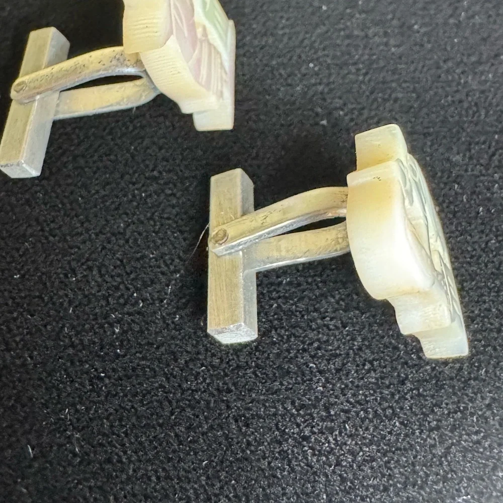 Vintage men’s carved mother of pearl cufflinks of women pouring grain